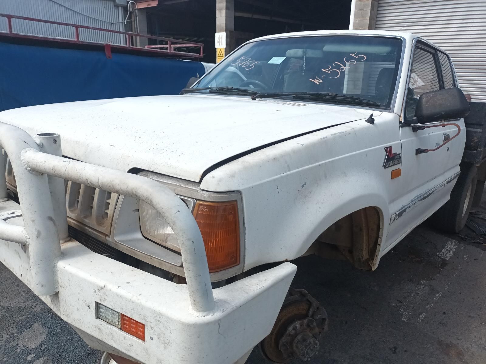 A White Truck is Parked on the Side of the Road — South West 4WD Wreckers In Brisbane, QLD