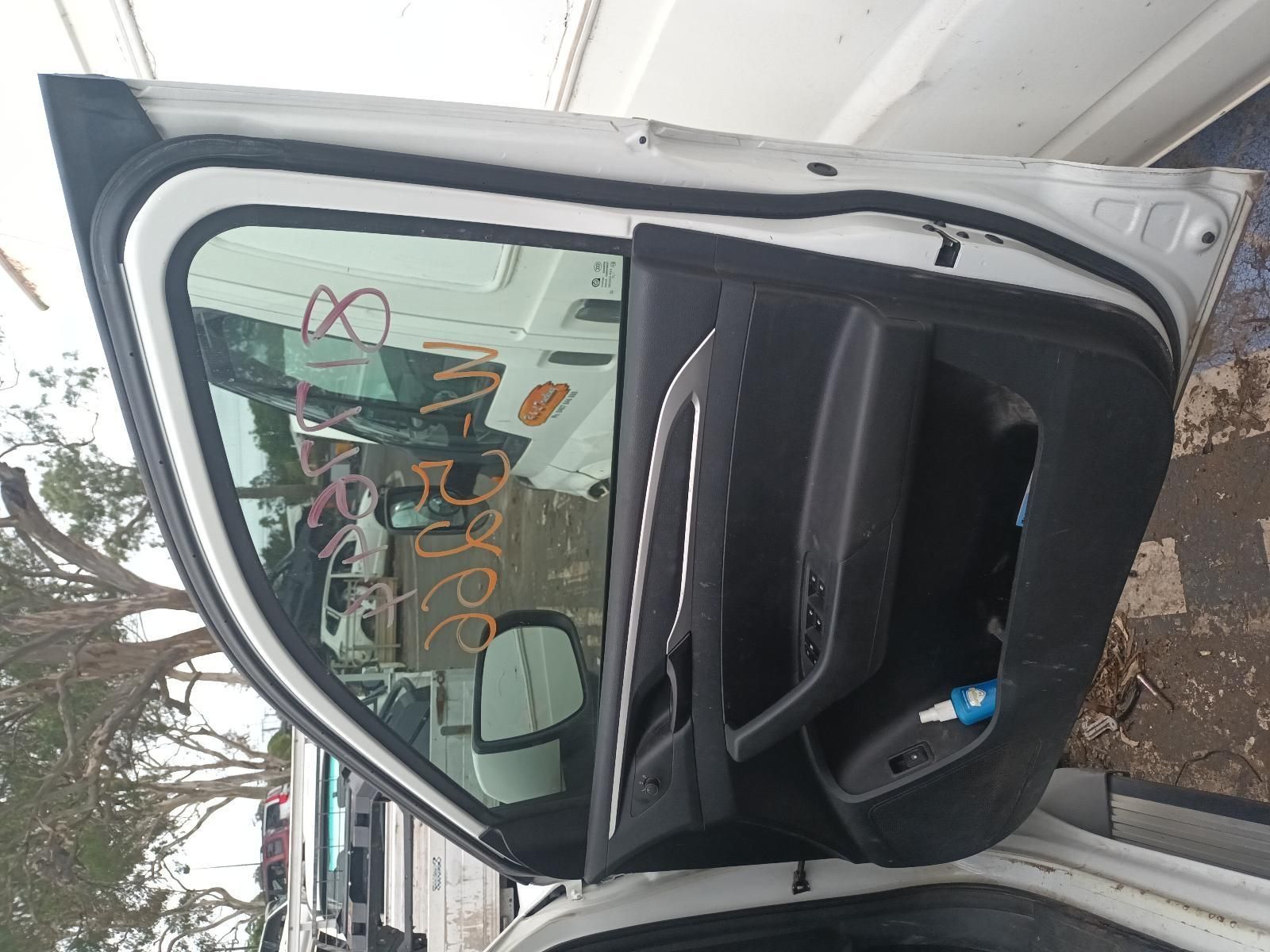 A White Car with the Door Open is Parked in Front of a Garage — South West 4WD Wreckers In Brisbane, QLD