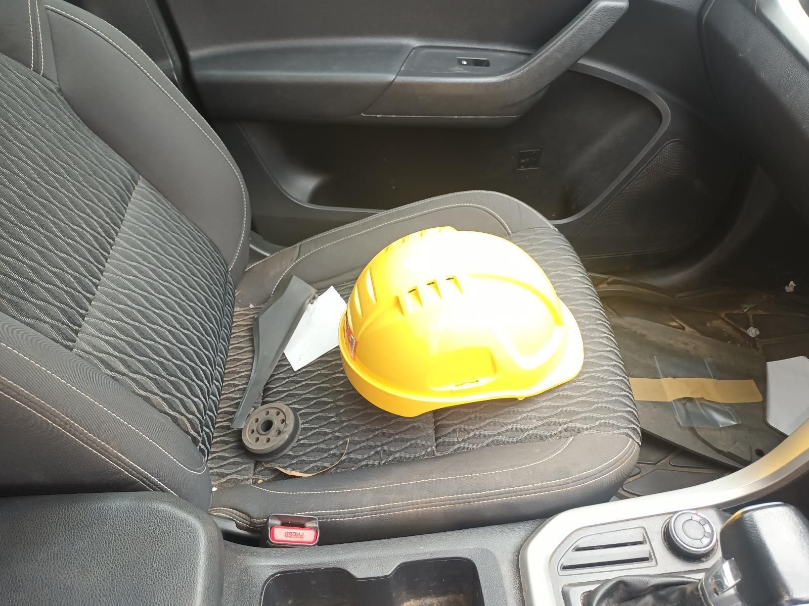 A Yellow Hard Hat is Sitting on the Seat of a Car — South West 4WD Wreckers In Brisbane, QLD