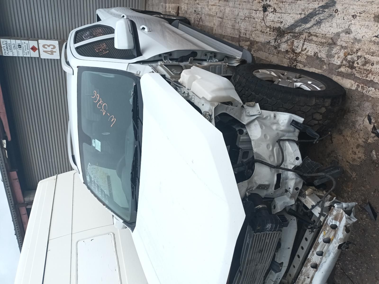 A White Car with the Hood Open is Sitting on the Ground — South West 4WD Wreckers In Brisbane, QLD