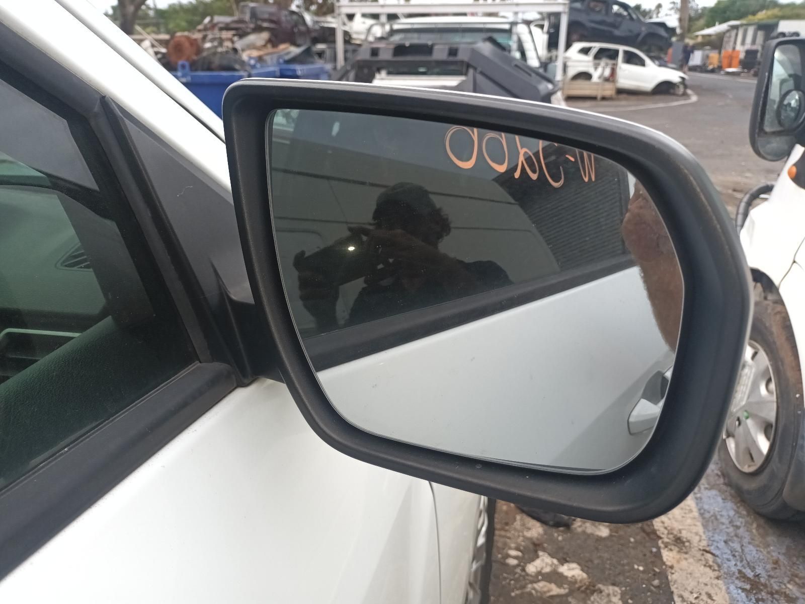 A Side View Mirror on a White Car with a Reflection of a Person in It — South West 4WD Wreckers In Brisbane, QLD