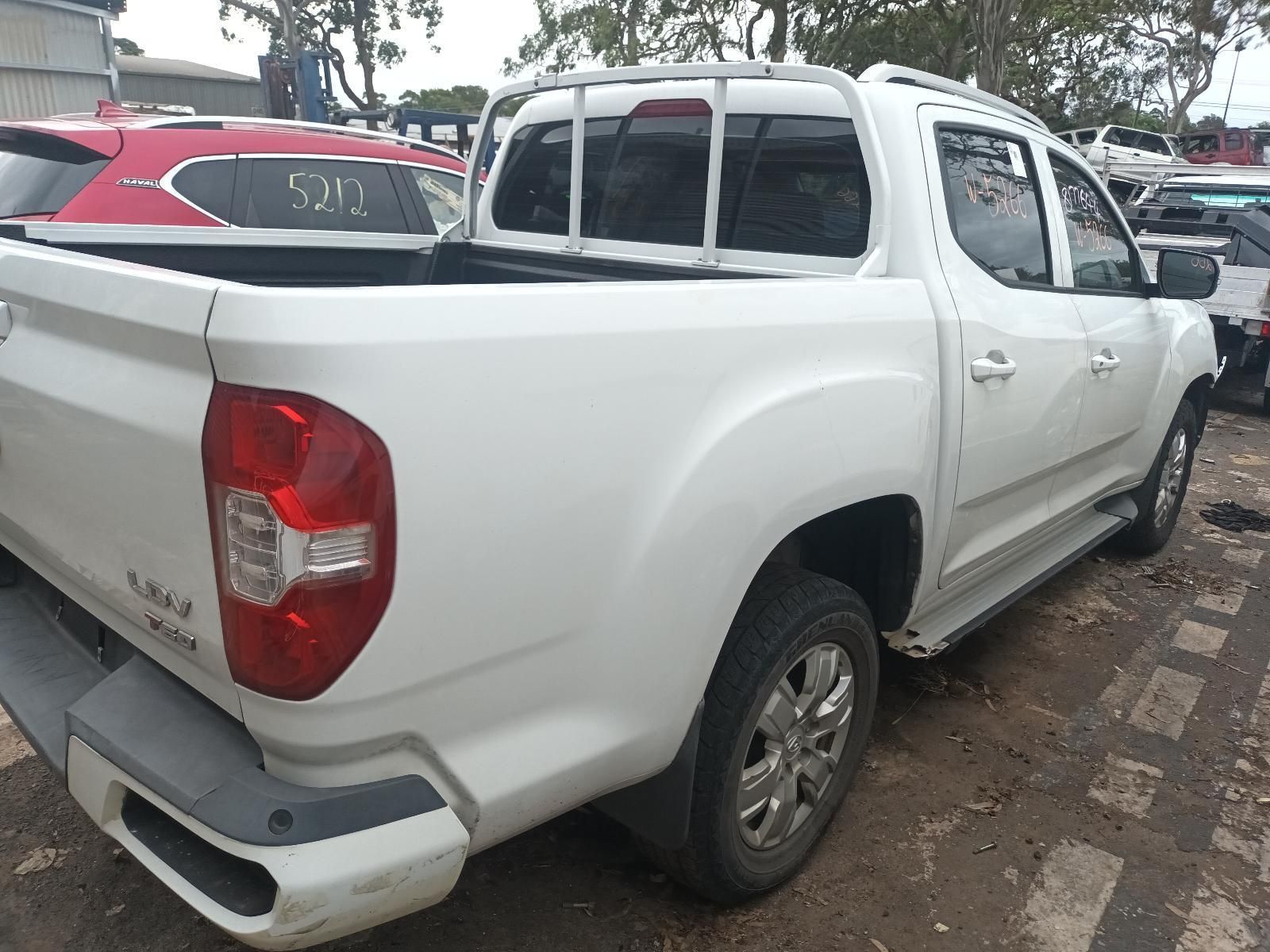 A White Truck with a Red Tail Light is Parked in a Lot — South West 4WD Wreckers In Brisbane, QLD