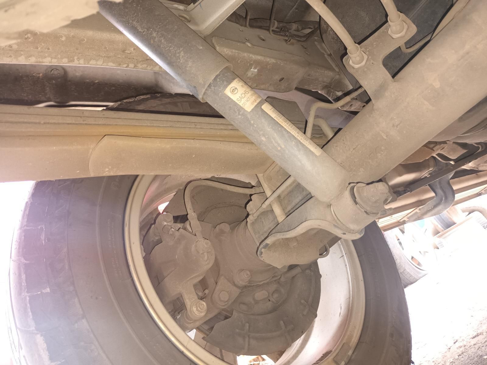 A Close Up of the Underside of a Car with a Shock Absorber and a Tire — South West 4WD Wreckers In Brisbane, QLD