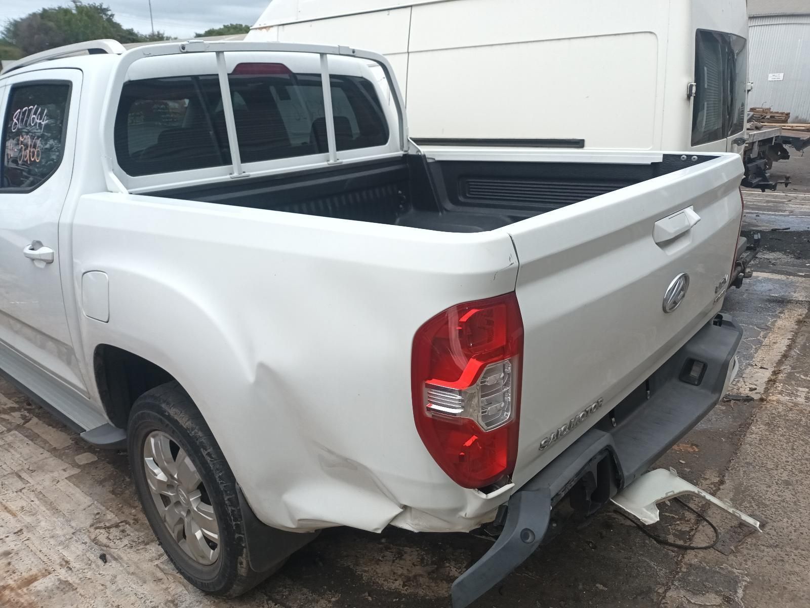 A White Truck with a Damaged Bed is Parked in a Parking Lot — South West 4WD Wreckers In Brisbane, QLD