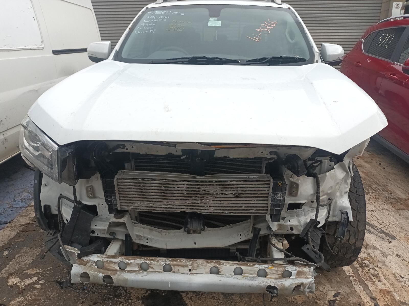 A White Truck with the Hood Off is Parked Next to a Red Car — South West 4WD Wreckers In Brisbane, QLD