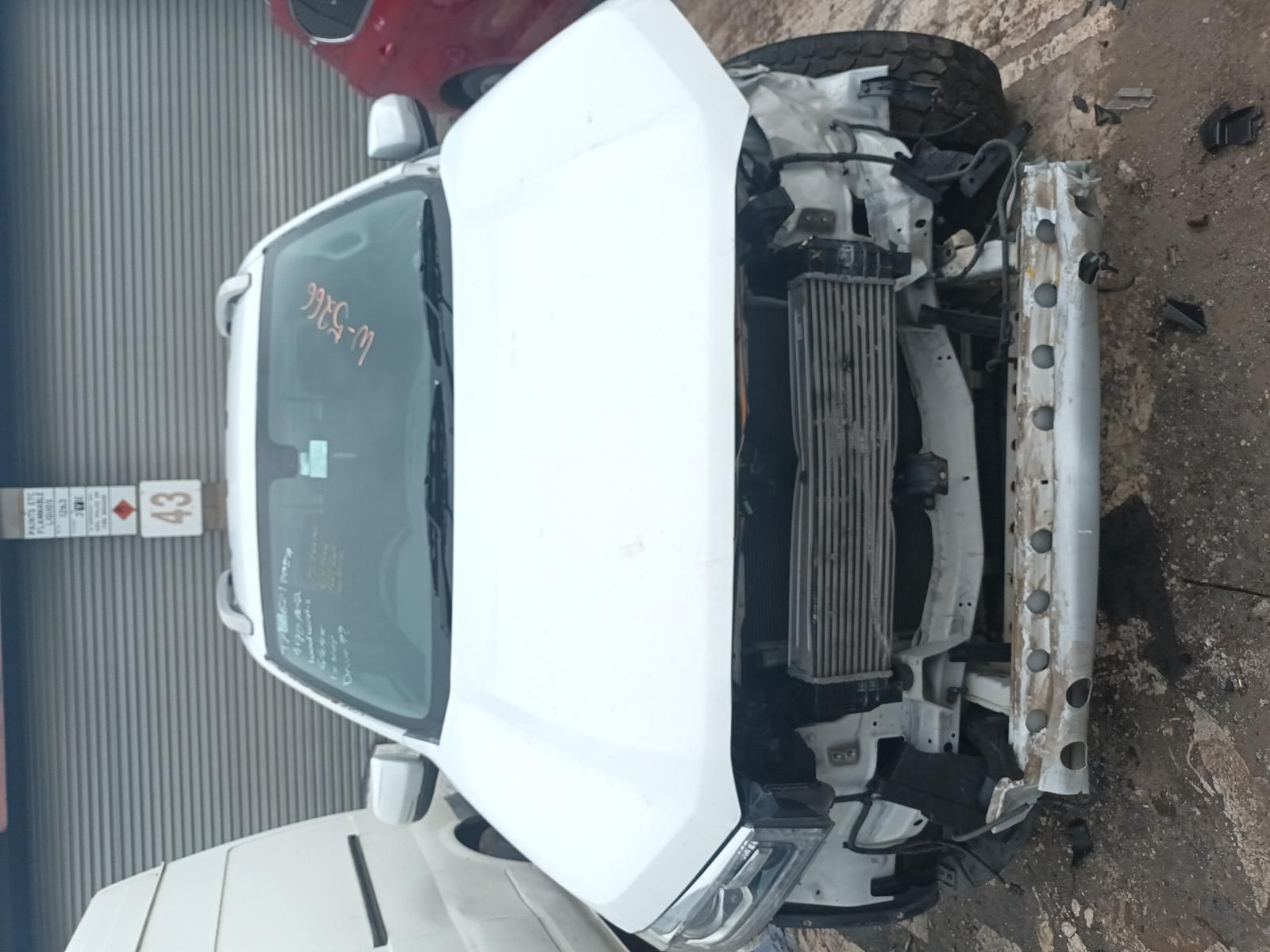 A White Truck with the Hood Removed is Parked Next to a Red Truck — South West 4WD Wreckers In Brisbane, QLD