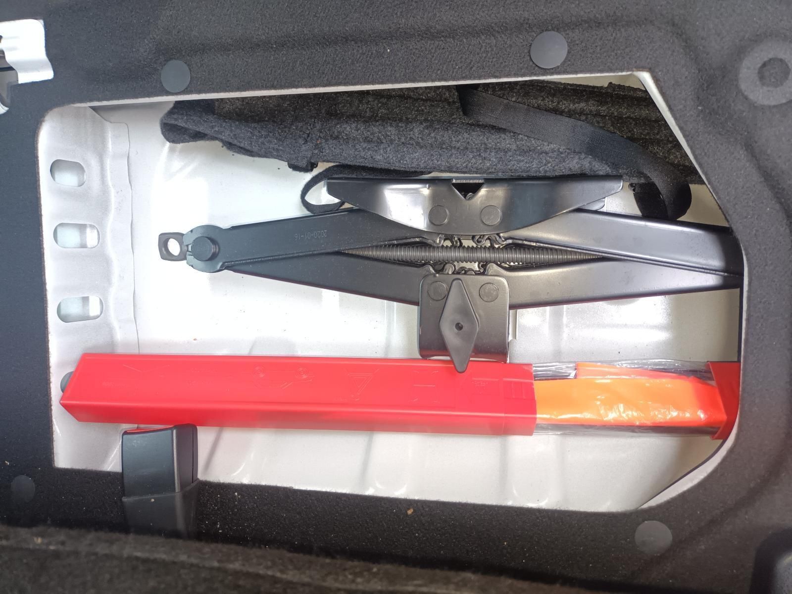 A Car Jack is Sitting in the Trunk of a Car — South West 4WD Wreckers In Brisbane, QLD
