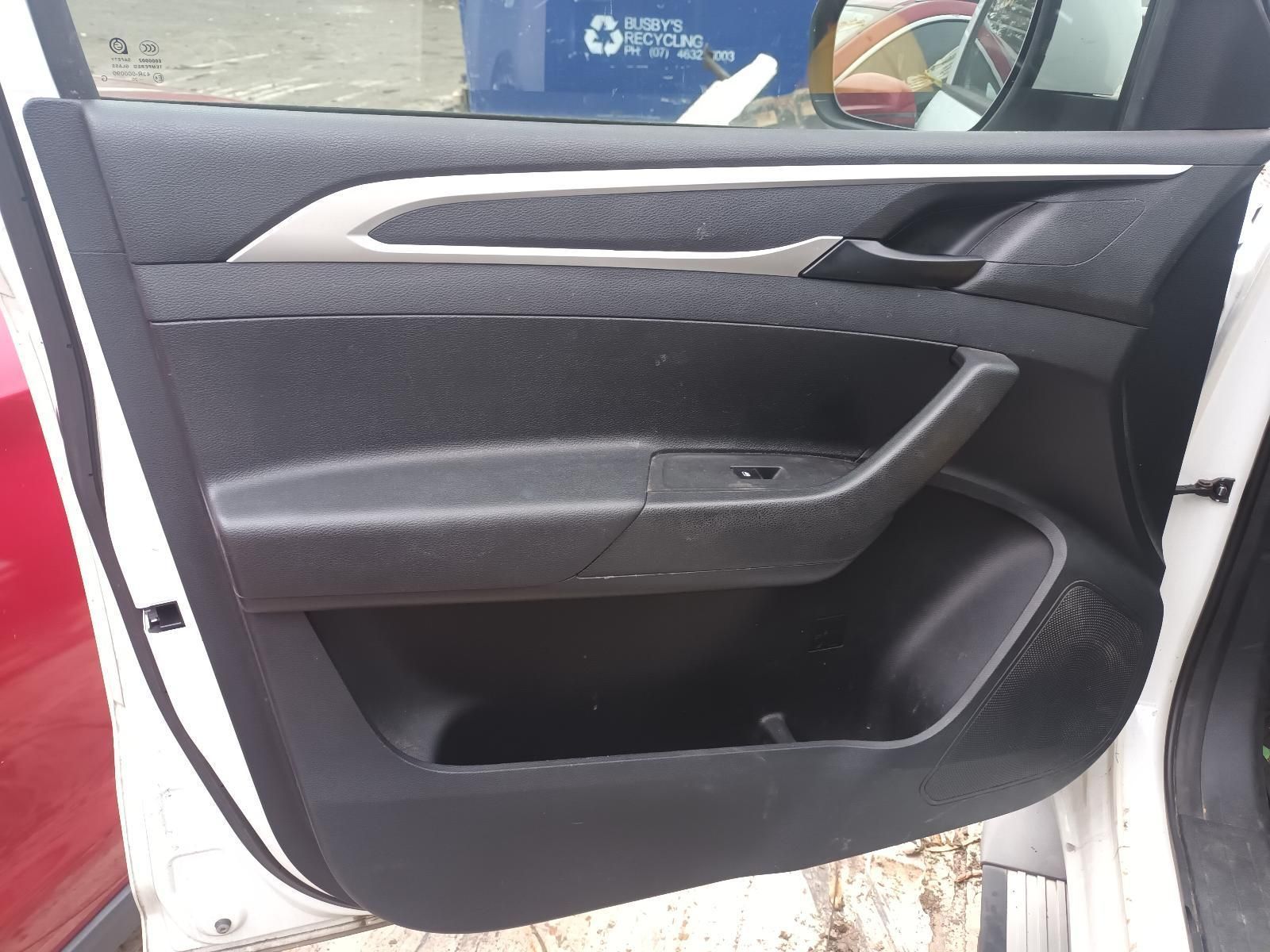 A White Car with the Door Open and a Trash Can in the Background — South West 4WD Wreckers In Brisbane, QLD