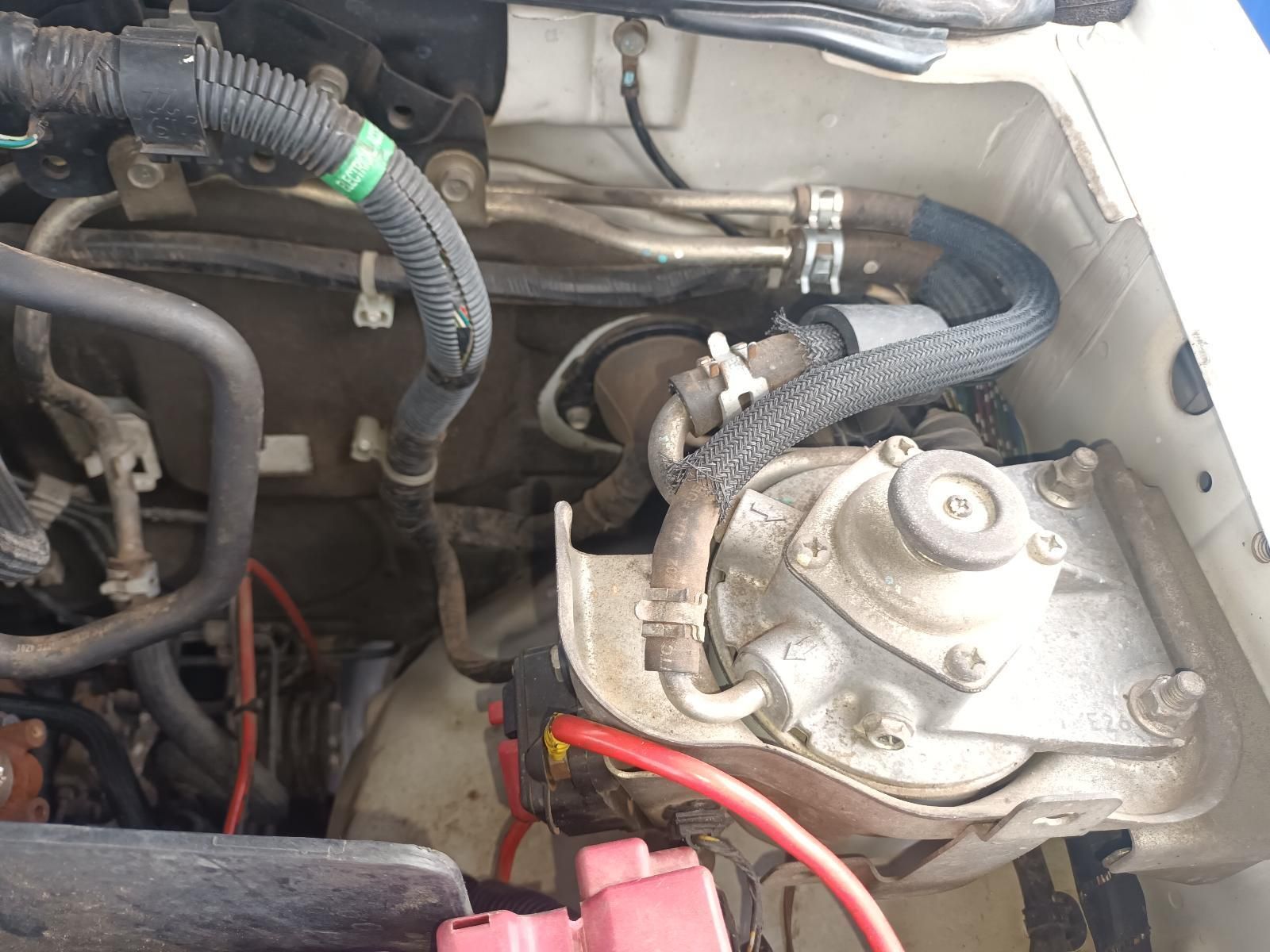 A Close Up of the Engine of a Car with a Red Battery — South West 4WD Wreckers In Brisbane, QLD