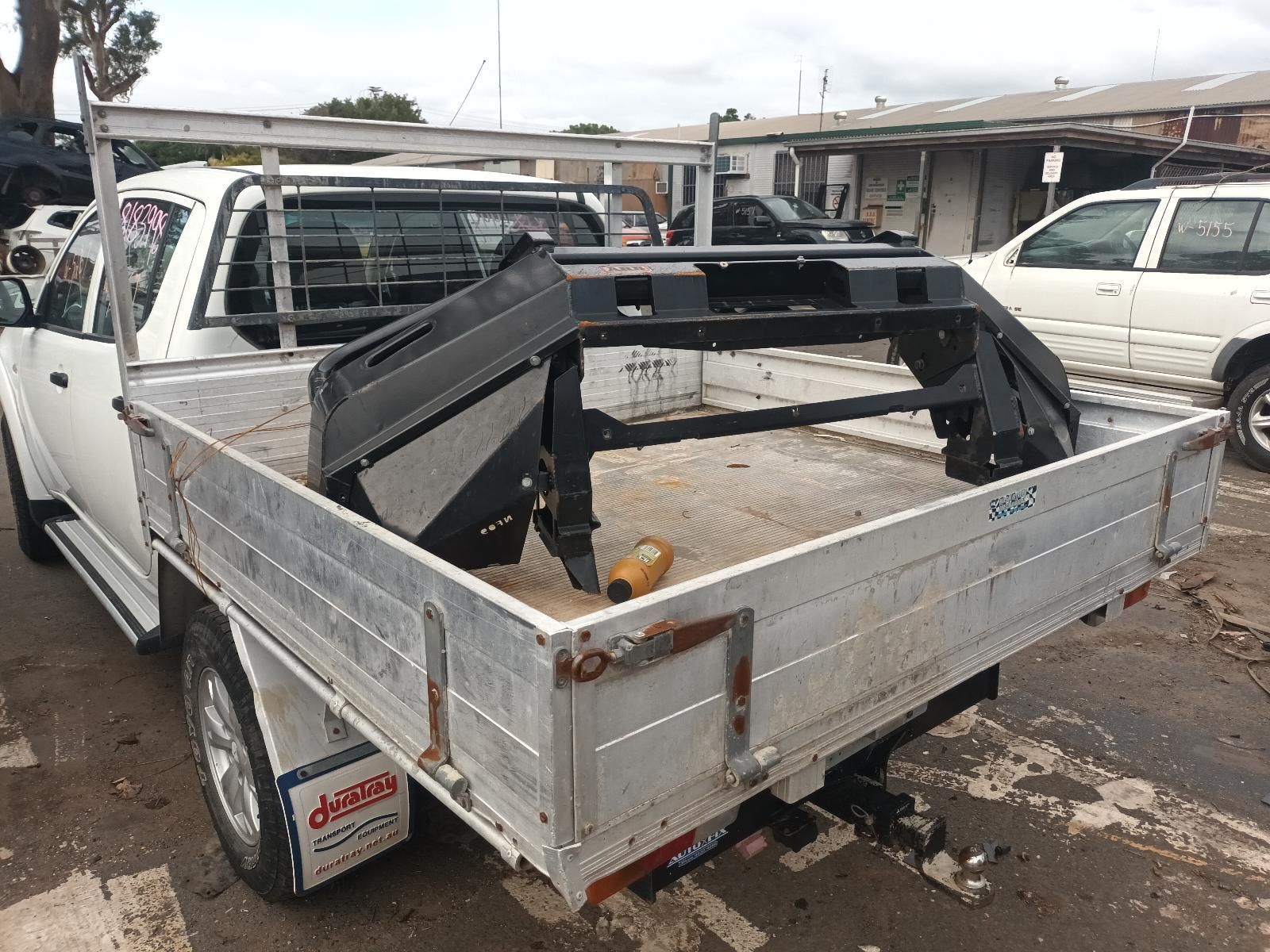 A White Truck with a Tray in the Back is Parked in a Parking Lot — South West 4WD Wreckers In Brisbane, QLD