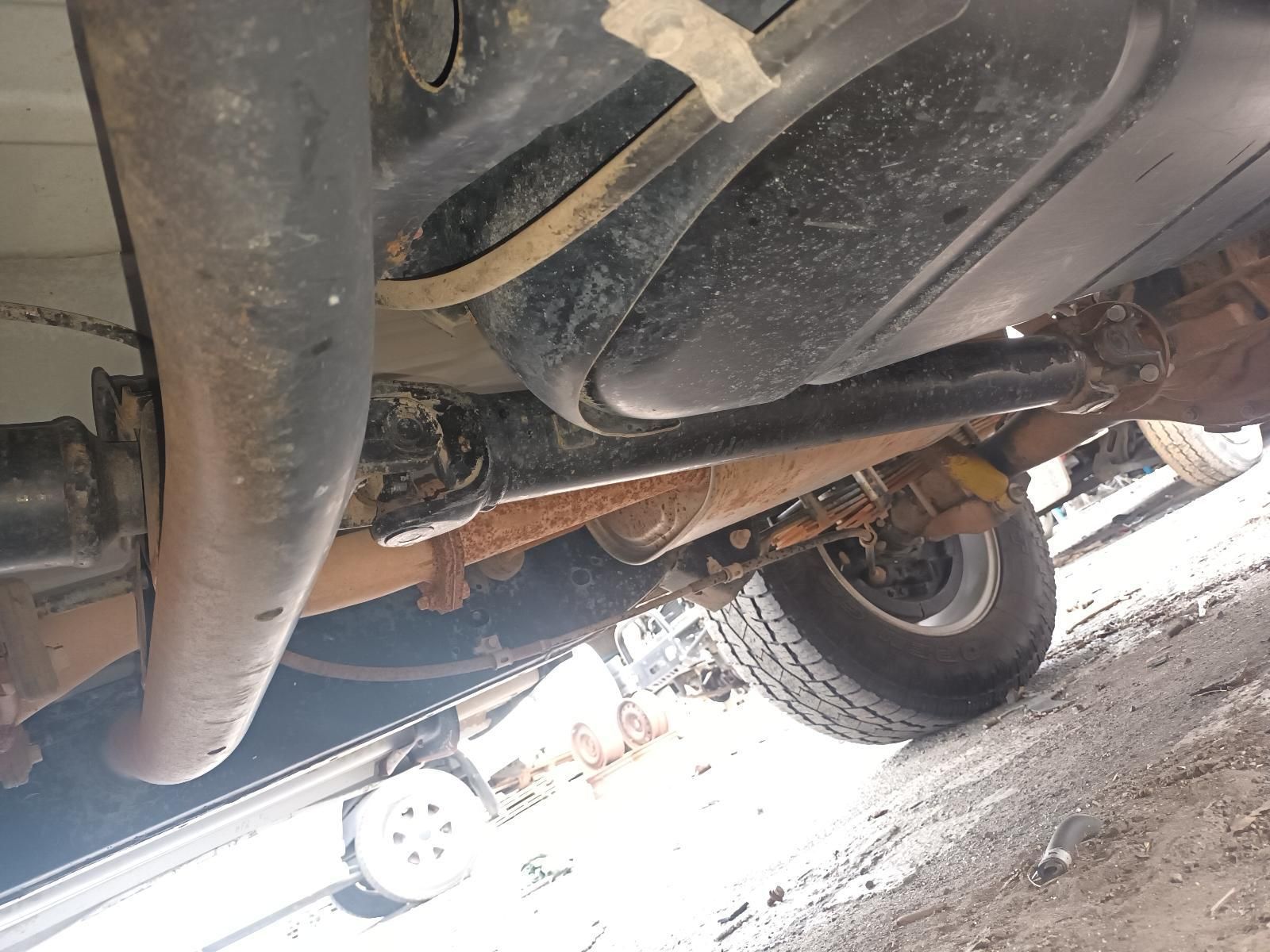 A Close Up of the Underside of a Car on a Dirt Road — South West 4WD Wreckers In Brisbane, QLD