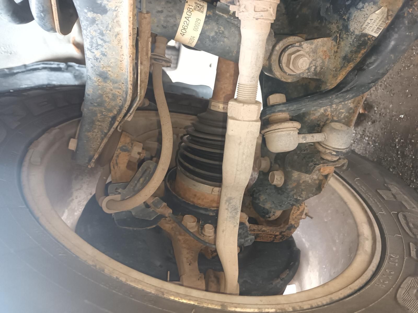 A Close Up of a Car's Suspension System with a Tire in the Background — South West 4WD Wreckers In Brisbane, QLD