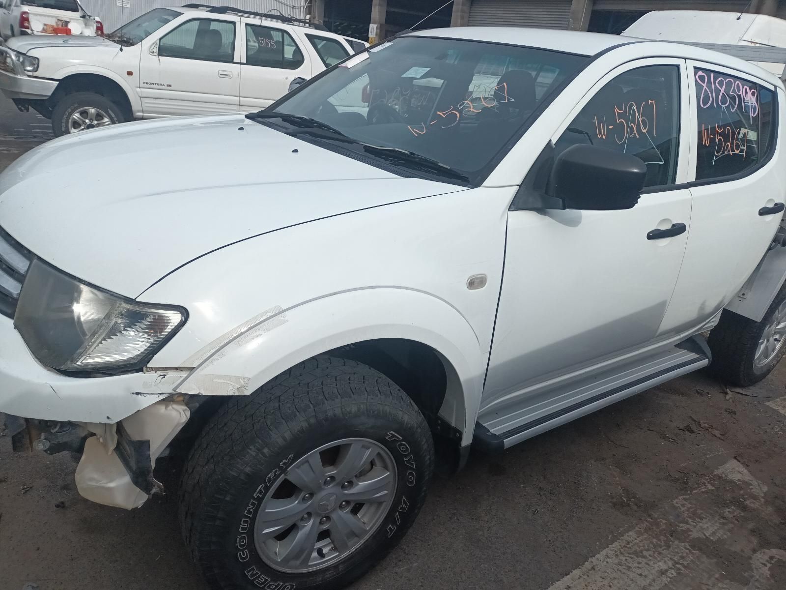 A White Truck is Parked on the Side of the Road — South West 4WD Wreckers In Brisbane, QLD