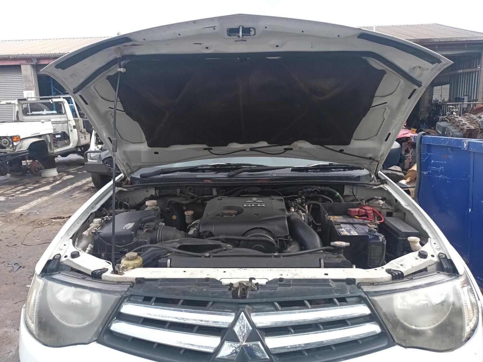 The Hood of a White Car is Open and the Engine is Visible — South West 4WD Wreckers In Brisbane, QLD