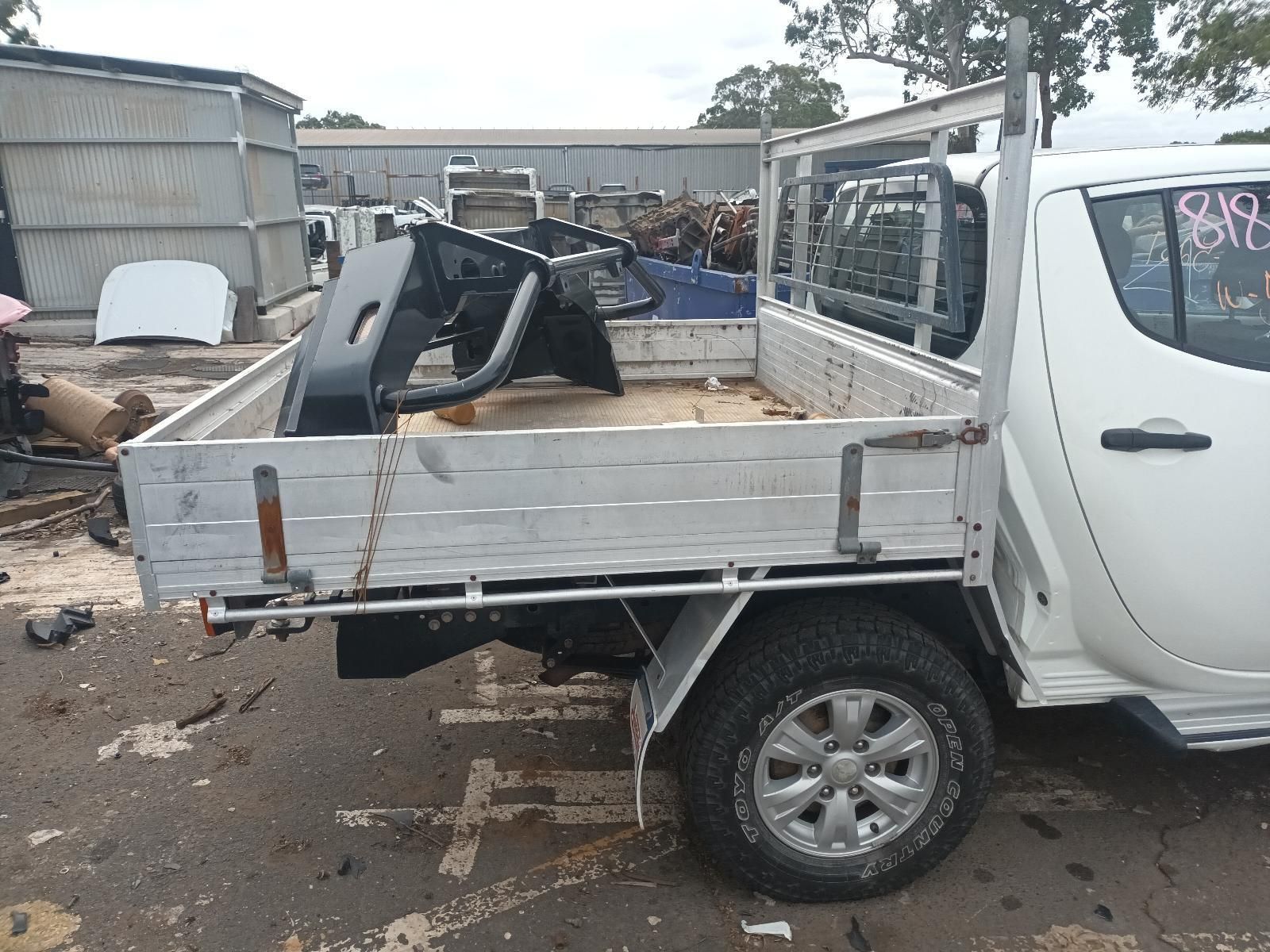 A White Truck with a Broken Bed is Parked on the Side of the Road — South West 4WD Wreckers In Brisbane, QLD
