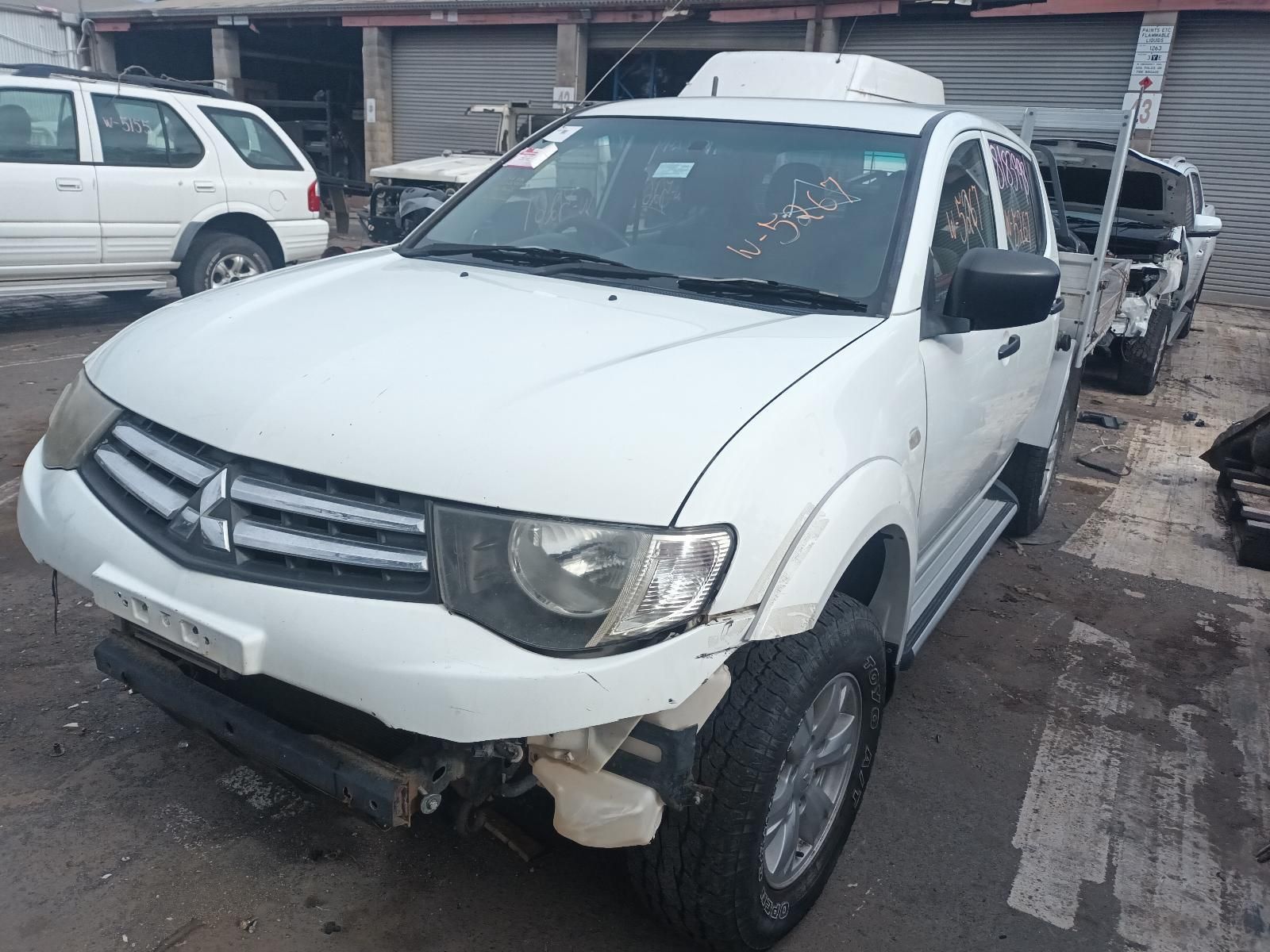 A White Truck is Sitting in a Parking Lot — South West 4WD Wreckers In Brisbane, QLD