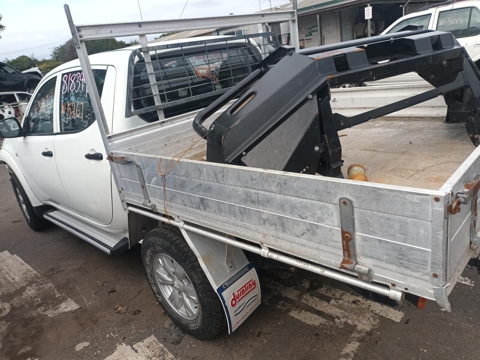 A White Truck with a Tray on the Back is Parked in a Parking Lot — South West 4WD Wreckers In Brisbane, QLD