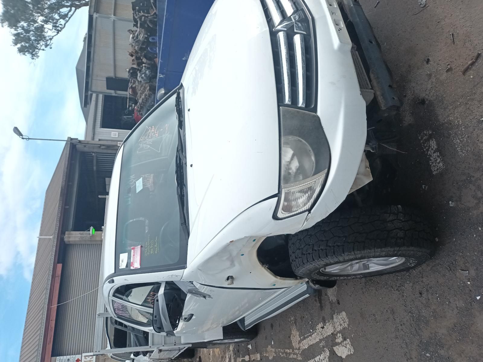 A White Truck is Parked in Front of a Building — South West 4WD Wreckers In Brisbane, QLD