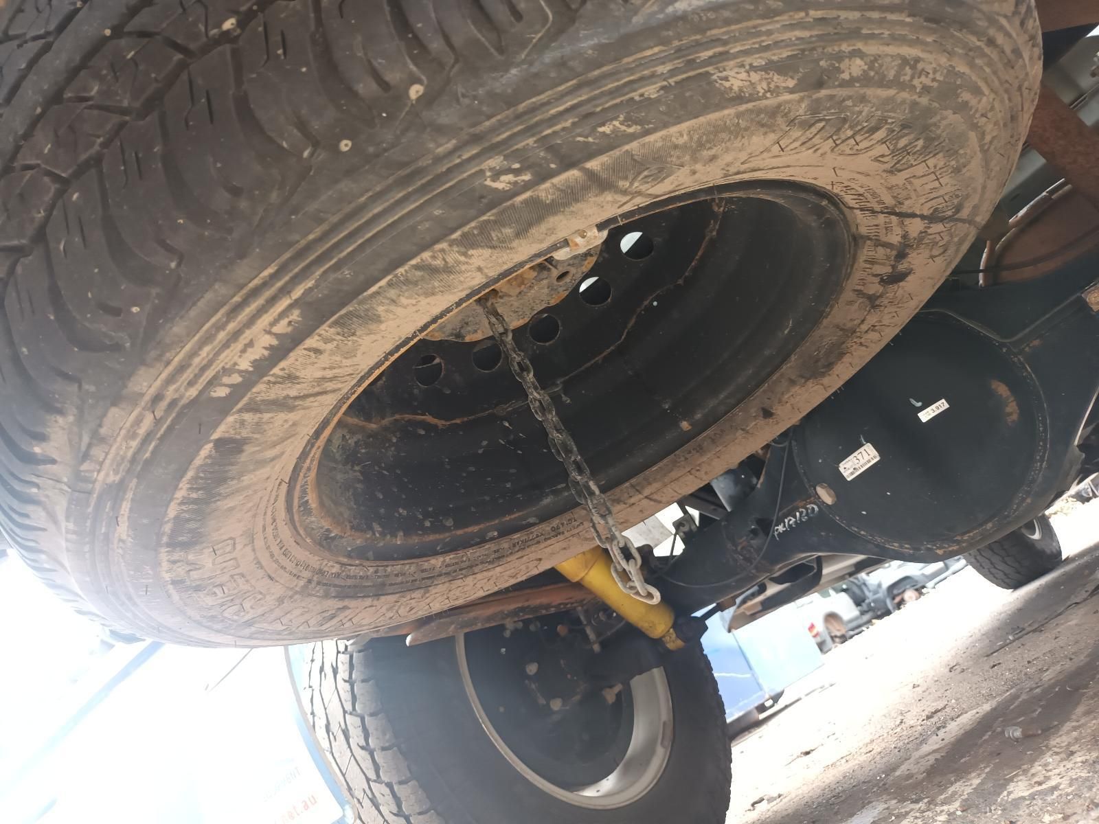 A Close Up of a Tire with a Chain Attached to It — South West 4WD Wreckers In Brisbane, QLD