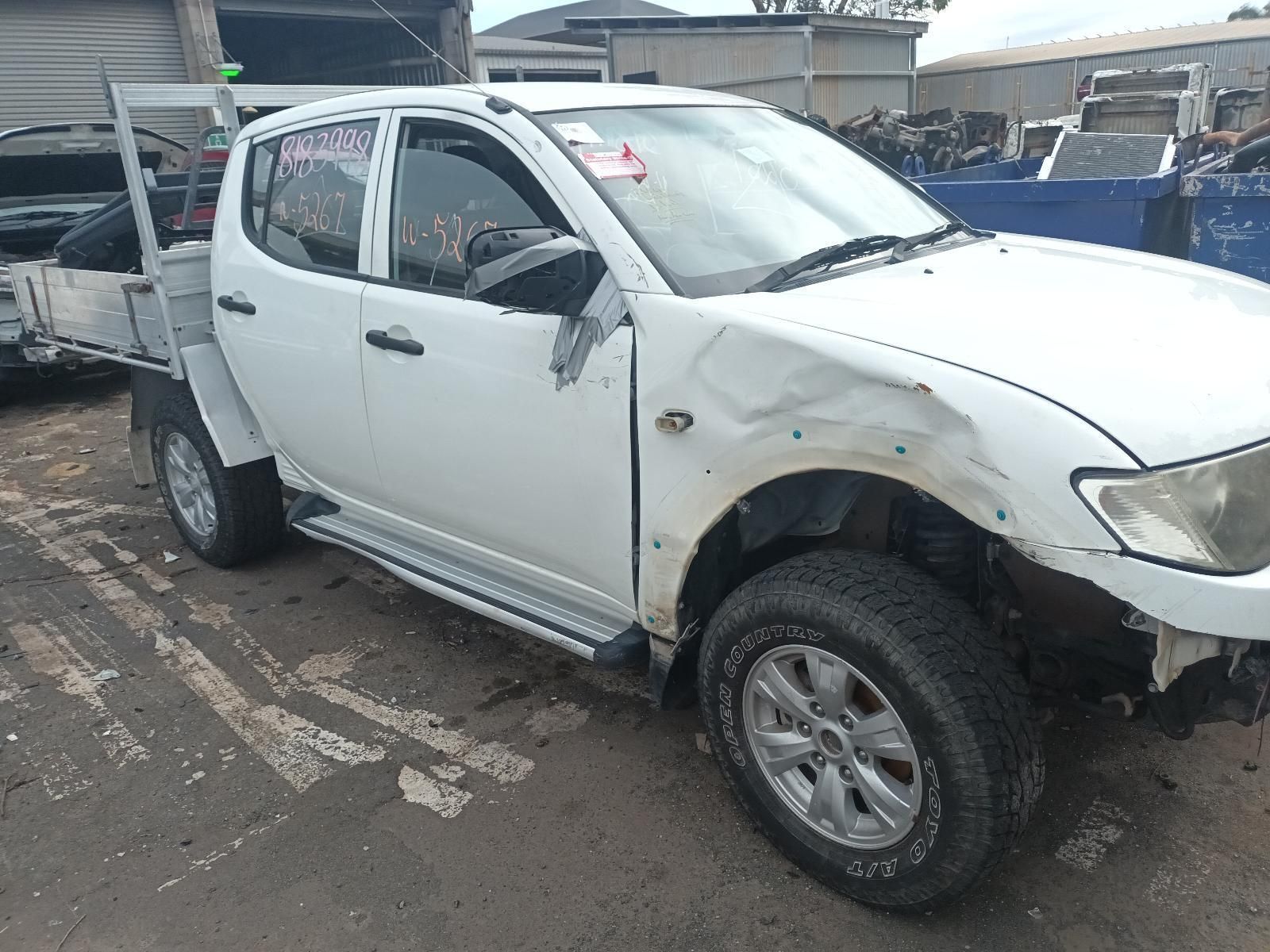 A White Truck with a Damaged Side is Parked in a Parking Lot — South West 4WD Wreckers In Brisbane, QLD