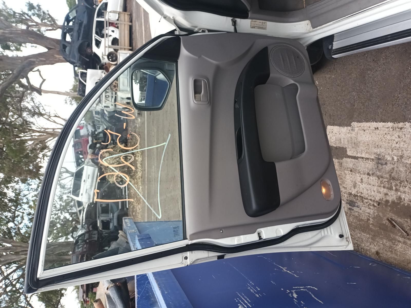 A White Car with the Door Open is Parked in a Parking Lot — South West 4WD Wreckers In Brisbane, QLD