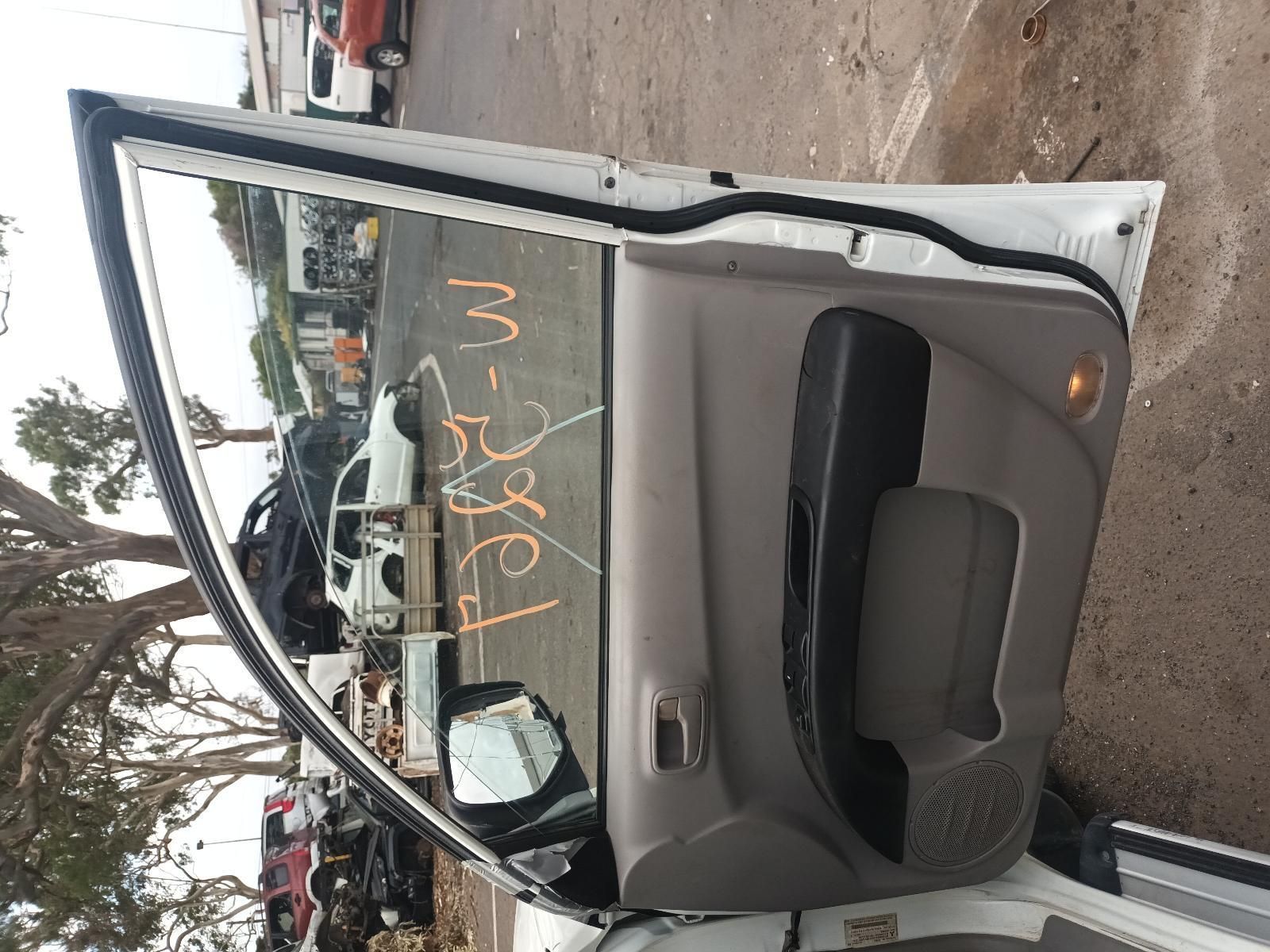 A White Car with the Door Open is Sitting in a Parking Lot — South West 4WD Wreckers In Brisbane, QLD
