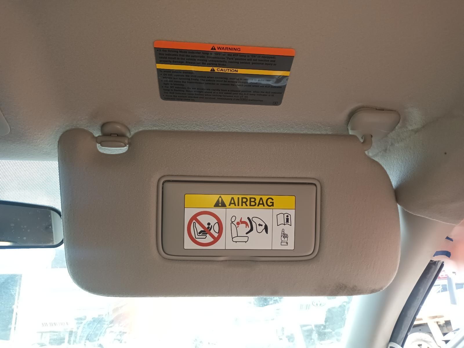 A Sun Visor with a Warning Label on It is Hanging from the Ceiling of a Car — South West 4WD Wreckers In Brisbane, QLD