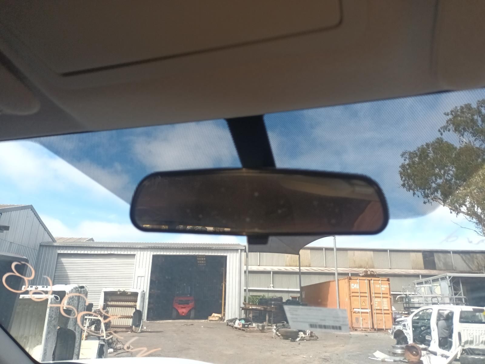A Rear View Mirror in a Car with a Garage in the Background — South West 4WD Wreckers In Brisbane, QLD