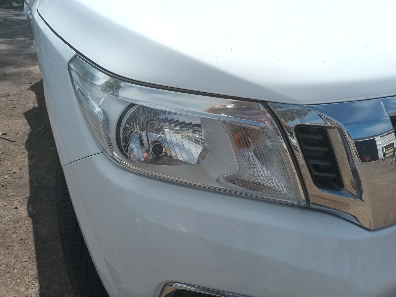 A Close Up of a White Car's Headlight on a Dirt Road — South West 4WD Wreckers In Brisbane, QLD