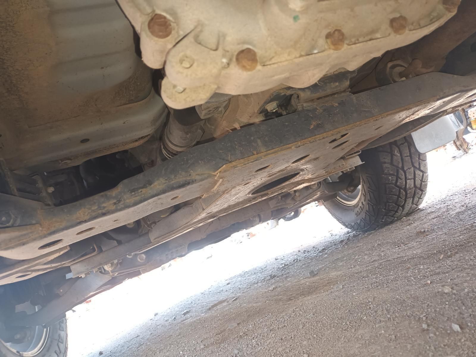 A Close Up of the Underside of a Car on a Dirt Road — South West 4WD Wreckers In Brisbane, QLD