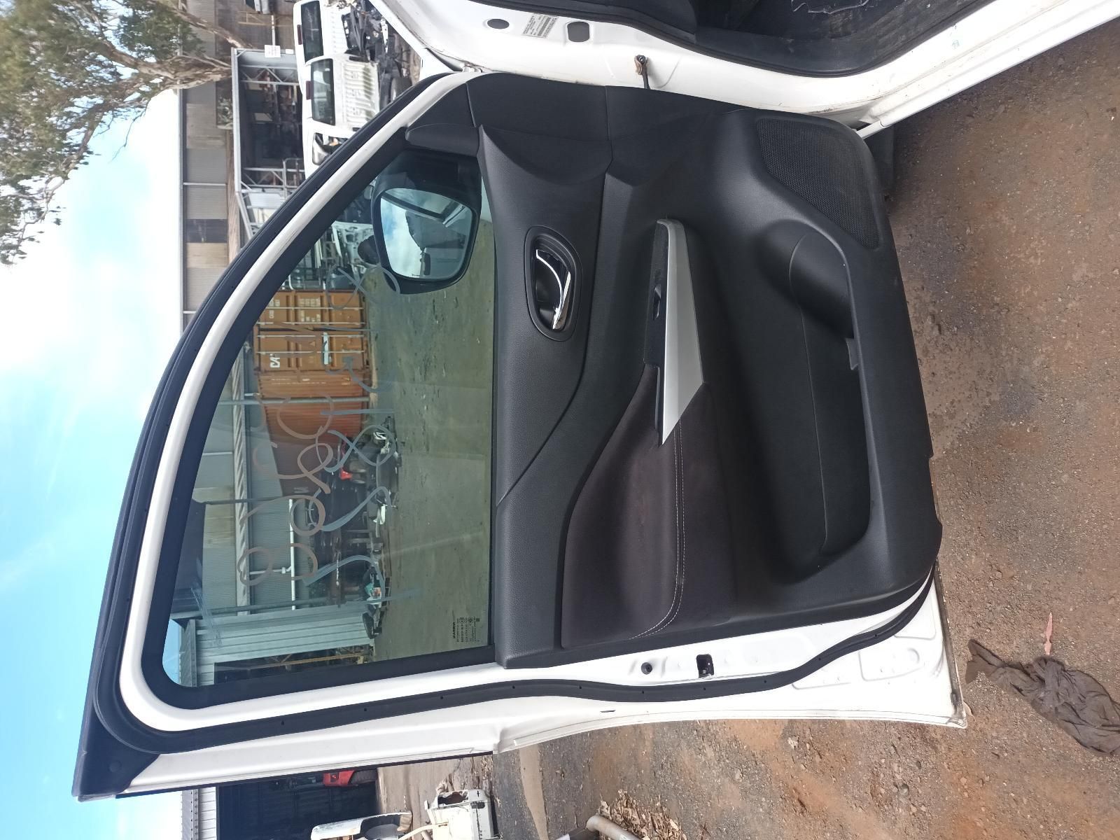 A White Car with the Door Open is Parked on the Side of the Road — South West 4WD Wreckers In Brisbane, QLD