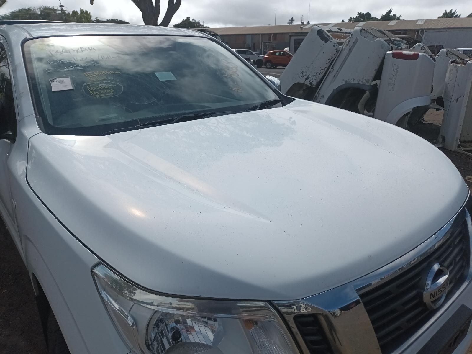 A White Nissan Truck is Parked in a Parking Lot — South West 4WD Wreckers In Brisbane, QLD