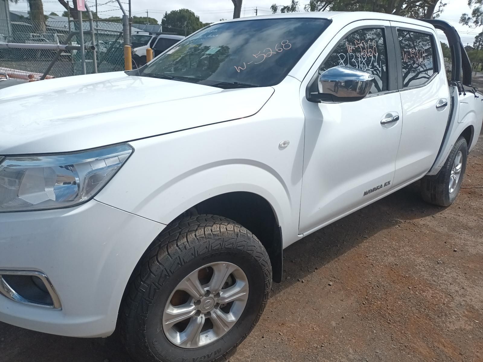 A White Pickup Truck is Parked in a Dirt Lot — South West 4WD Wreckers In Brisbane, QLD