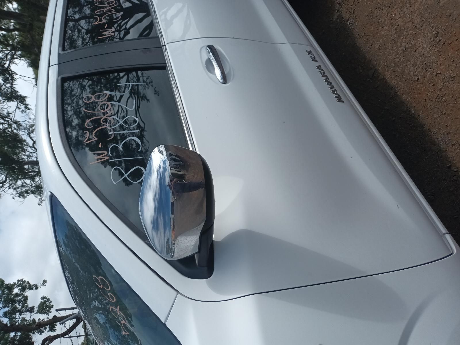 A White Car is Parked on the Side of the Road — South West 4WD Wreckers In Brisbane, QLD