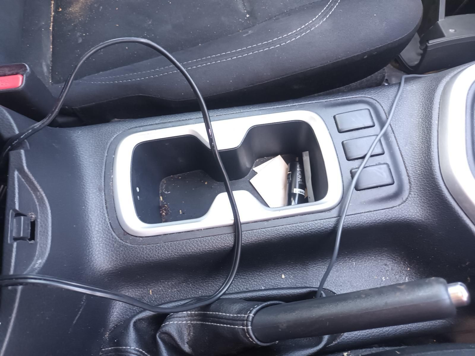 A Cord is Plugged Into the Center Console of a Car — South West 4WD Wreckers In Brisbane, QLD