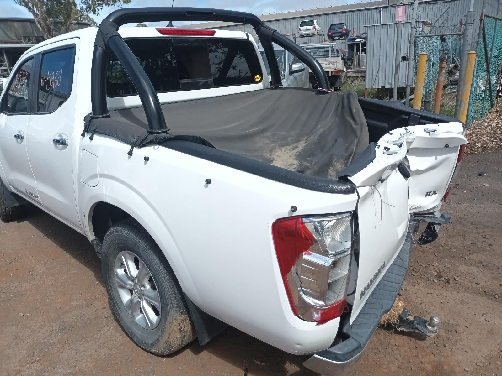 A White Pickup Truck is Parked in a Dirt Lot — South West 4WD Wreckers In Brisbane, QLD