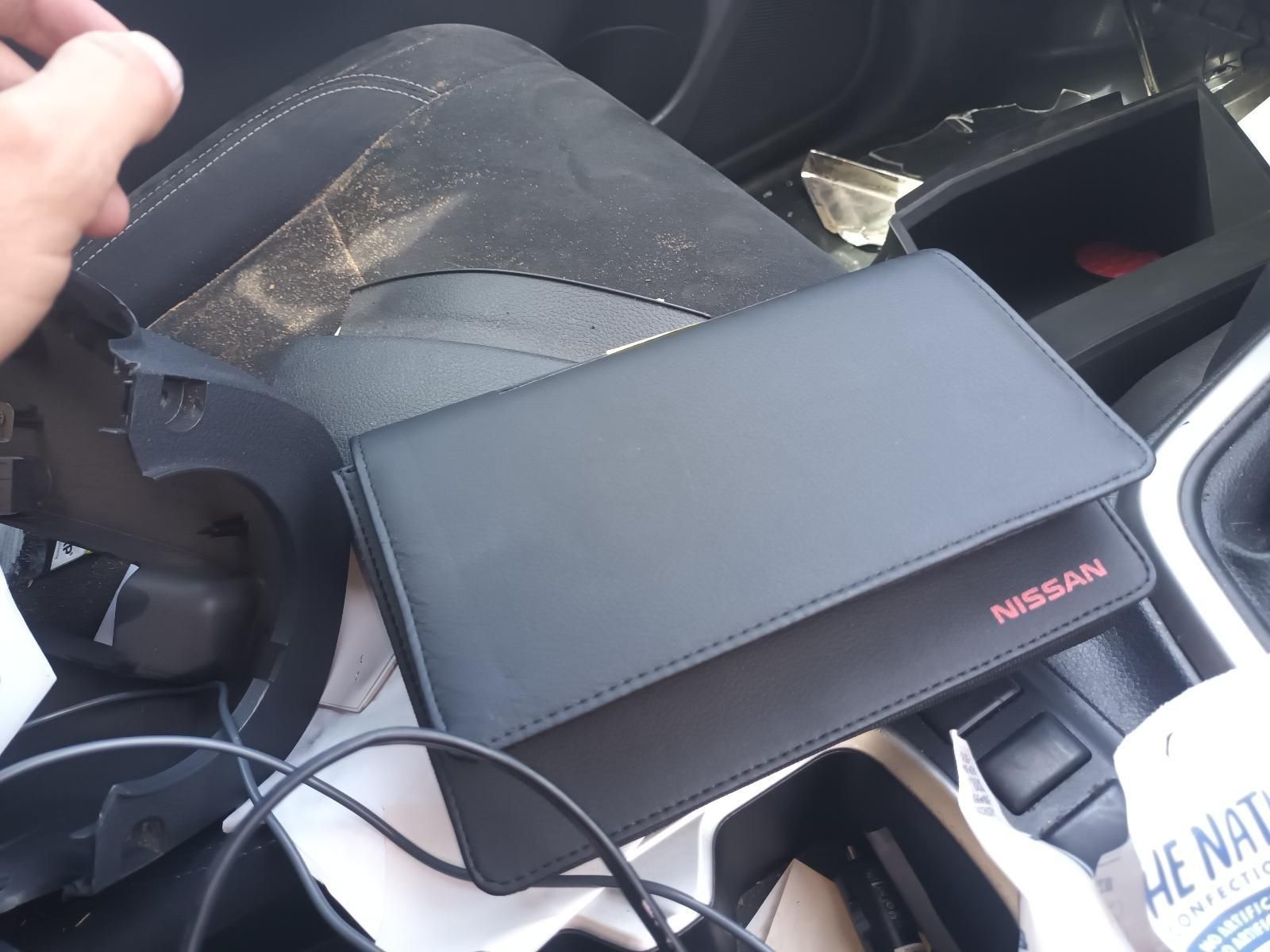A Black Nissan Wallet Sits in the Center Console of a Car — South West 4WD Wreckers In Brisbane, QLD