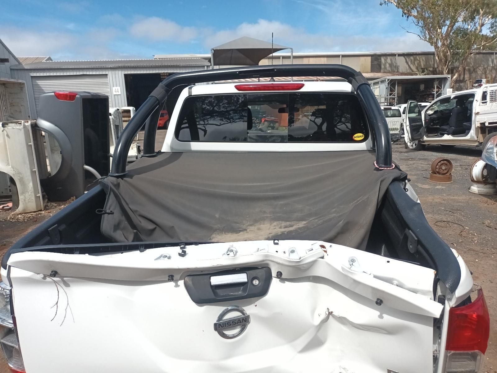 The Back of a White Nissan Truck is Damaged — South West 4WD Wreckers In Brisbane, QLD