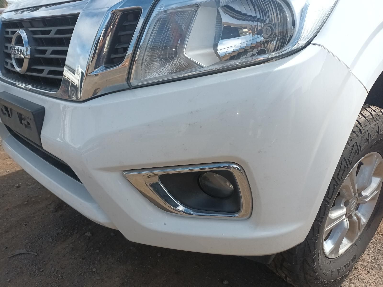 A White Nissan Truck is Parked on a Dirt Road — South West 4WD Wreckers In Brisbane, QLD