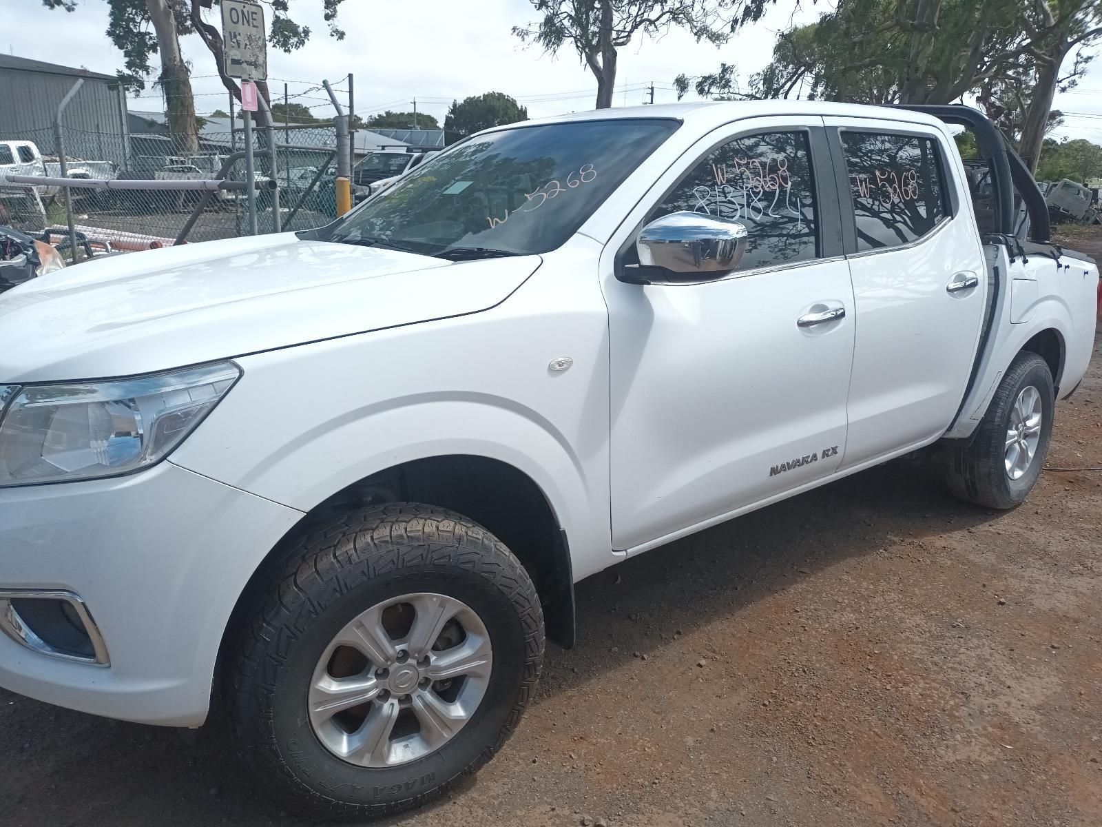 A White Pickup Truck is Parked in a Dirt Lot — South West 4WD Wreckers In Brisbane, QLD