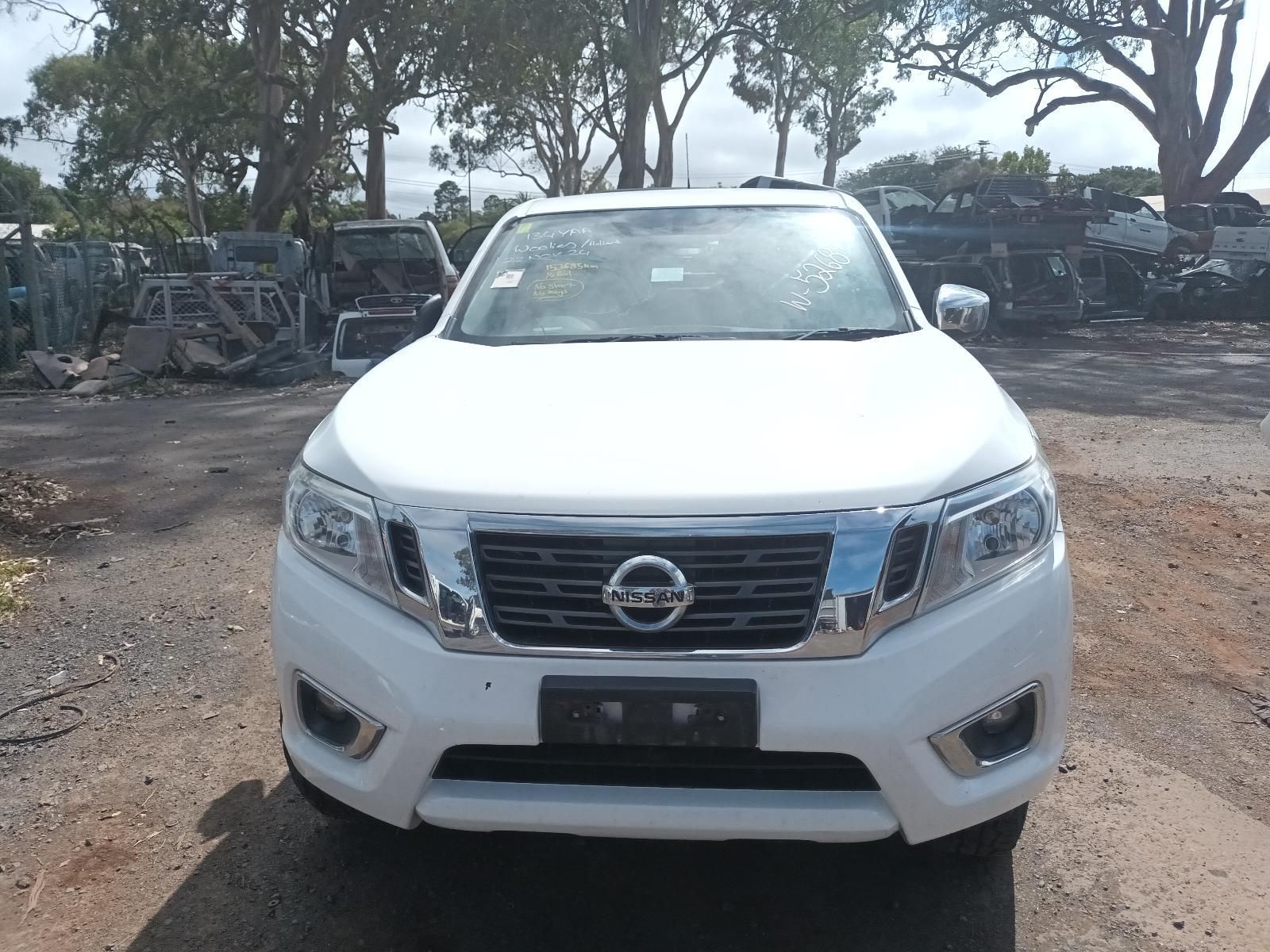 A White Nissan Truck is Parked in a Gravel Lot — South West 4WD Wreckers In Brisbane, QLD