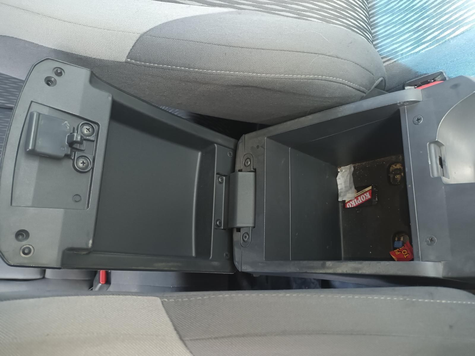 The Center Console of a Car is Open and Filled with Various Items — South West 4WD Wreckers In Brisbane, QLD