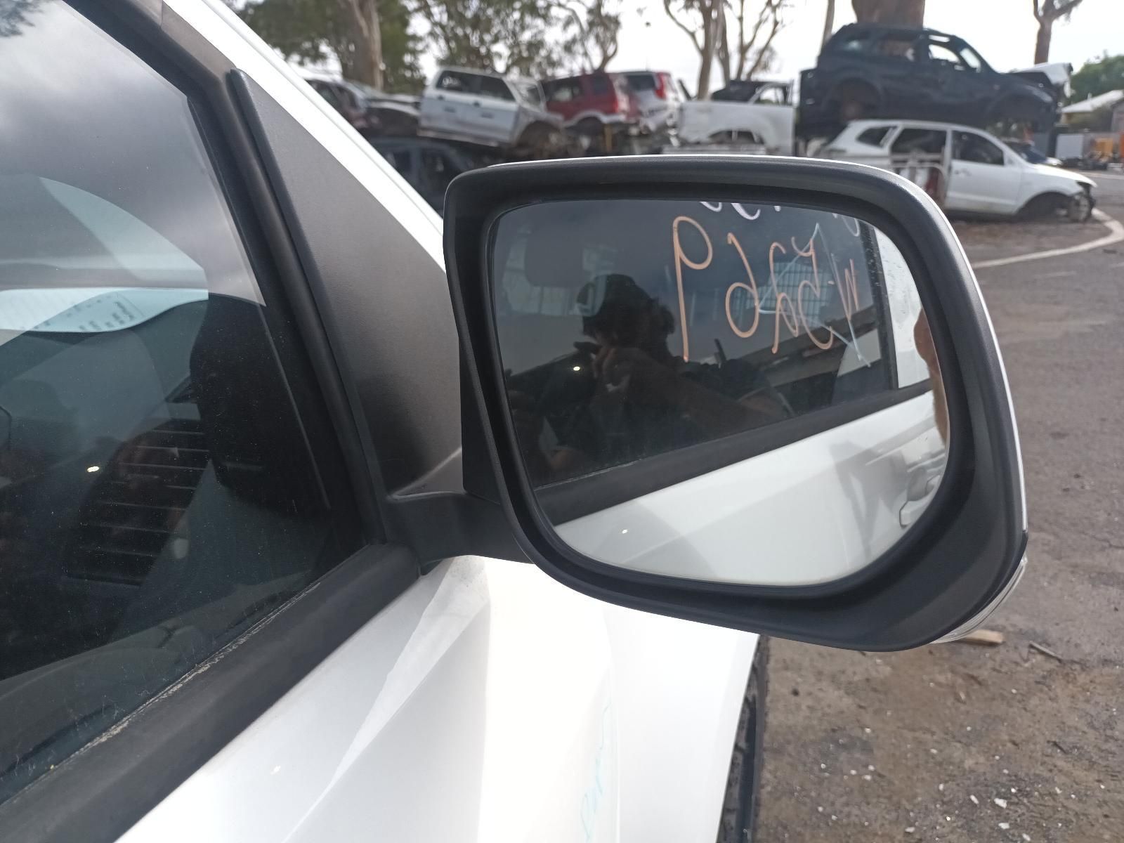 A Side View Mirror on a White Car — South West 4WD Wreckers In Brisbane, QLD