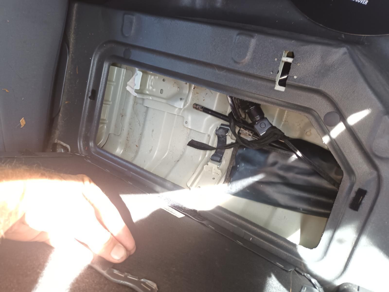 A Person is Holding a Piece of Paper in the Back of a Car — South West 4WD Wreckers In Brisbane, QLD