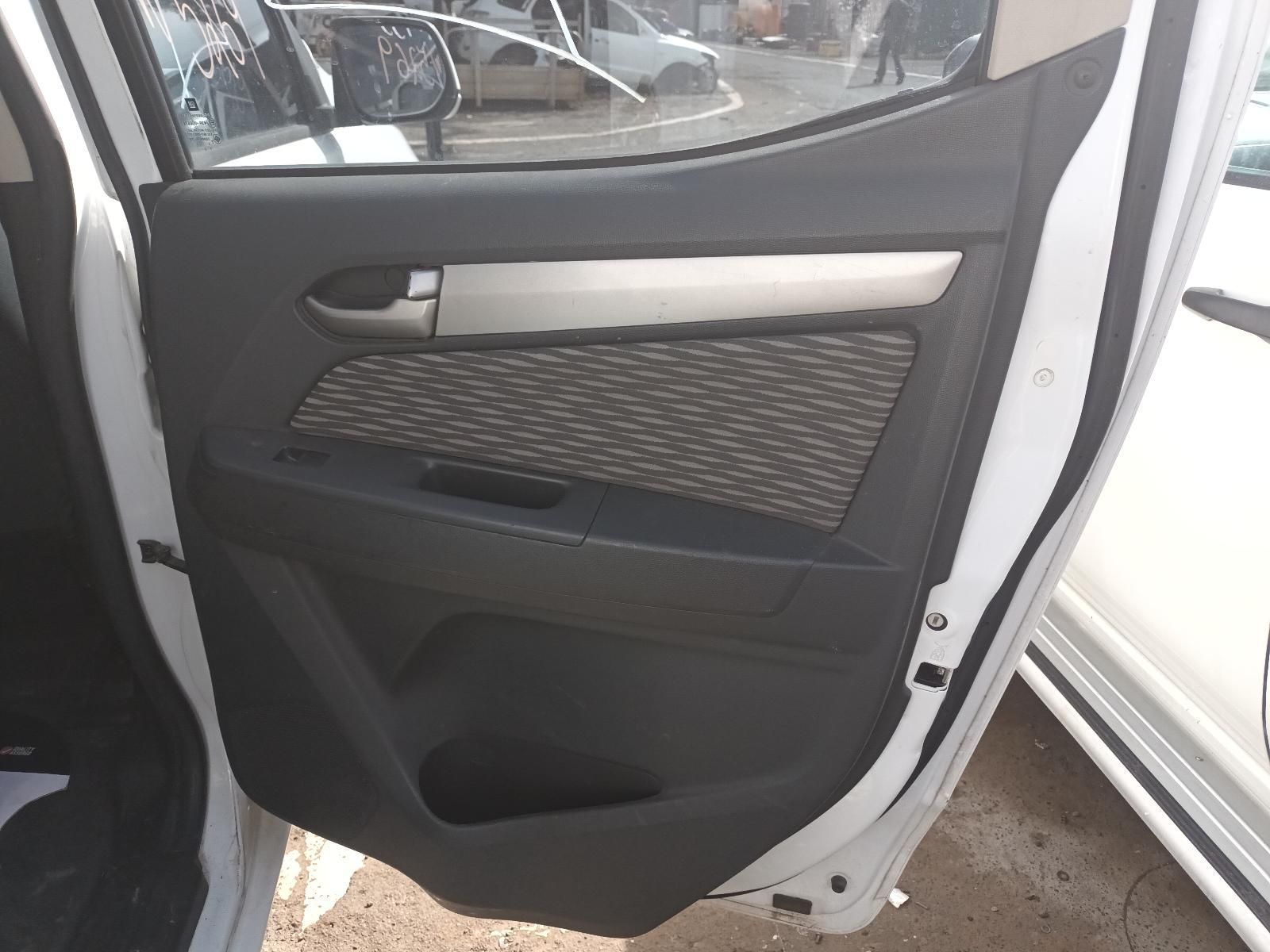 A White Car with the Door Open is Parked on the Side of the Road — South West 4WD Wreckers In Brisbane, QLD