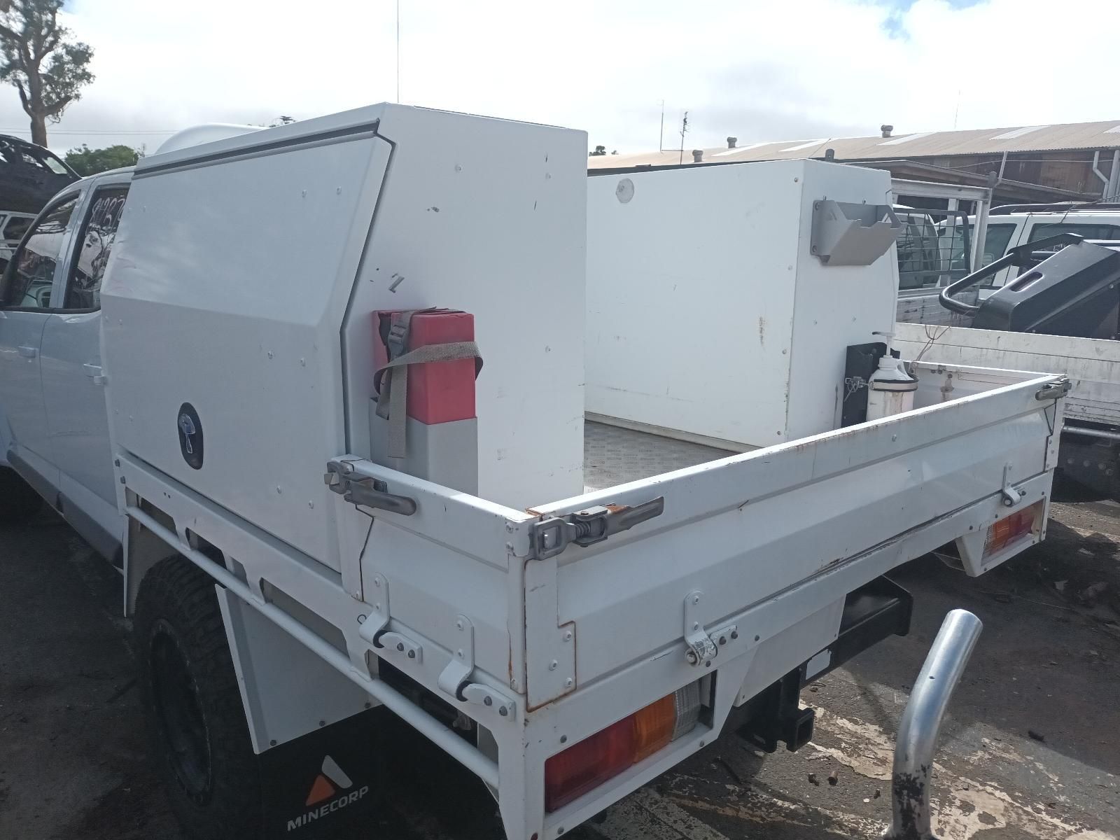 A White Truck with a Tray and a Canopy is Parked in a Parking Lot — South West 4WD Wreckers In Brisbane, QLD