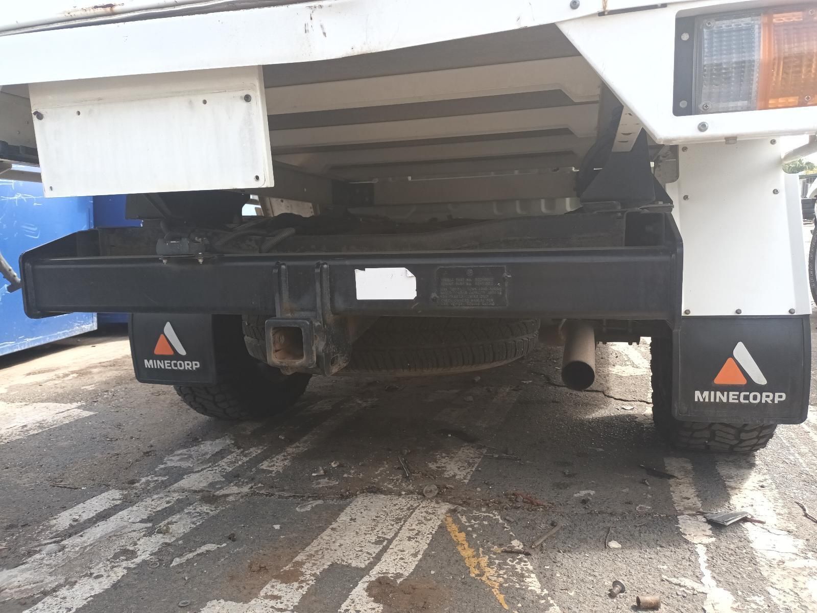 A White Truck with Black Mud Flaps is Parked in a Parking Lot — South West 4WD Wreckers In Brisbane, QLD