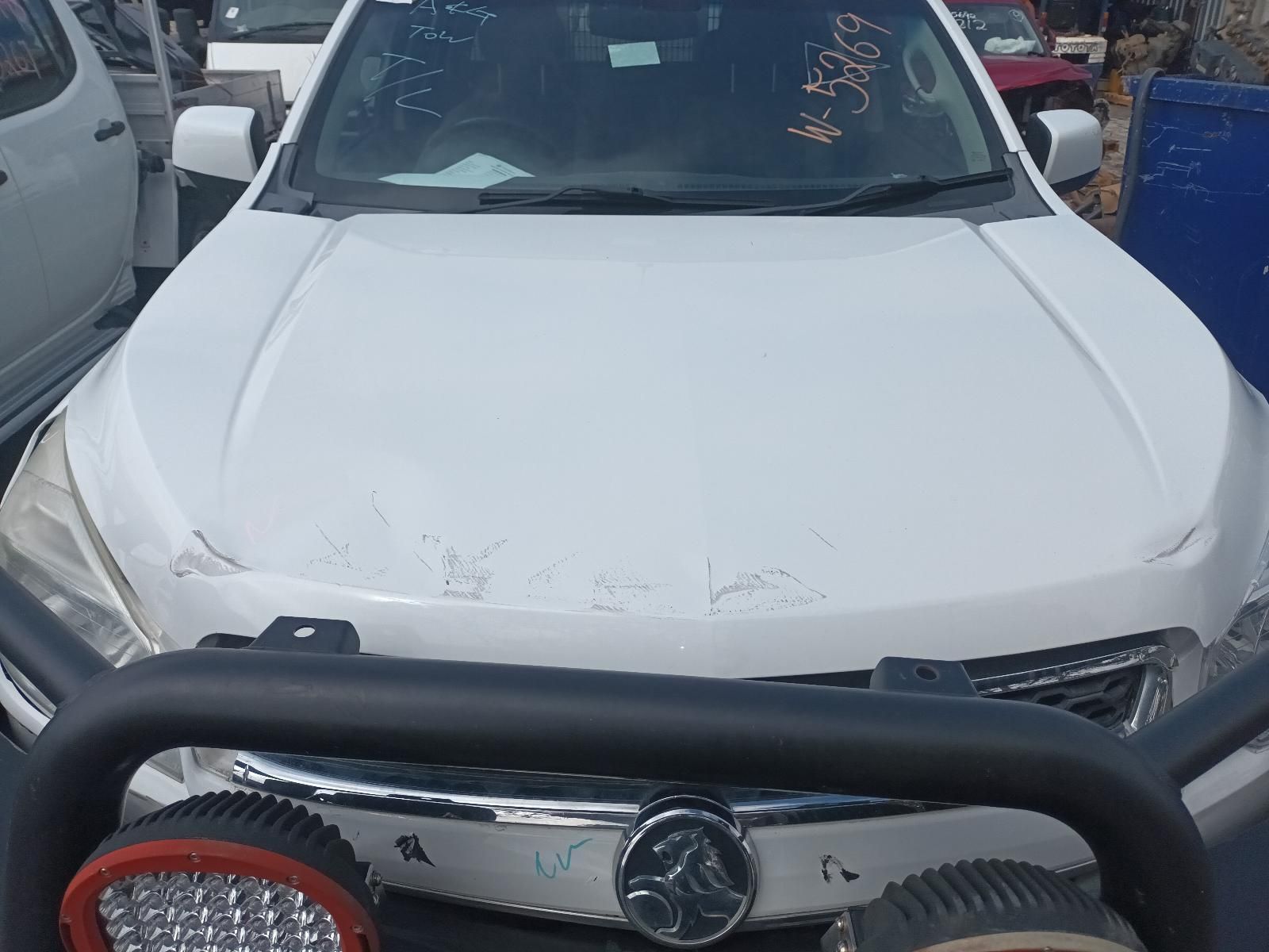 A White Car with a Black Bumper is Parked in a Parking Lot — South West 4WD Wreckers In Brisbane, QLD