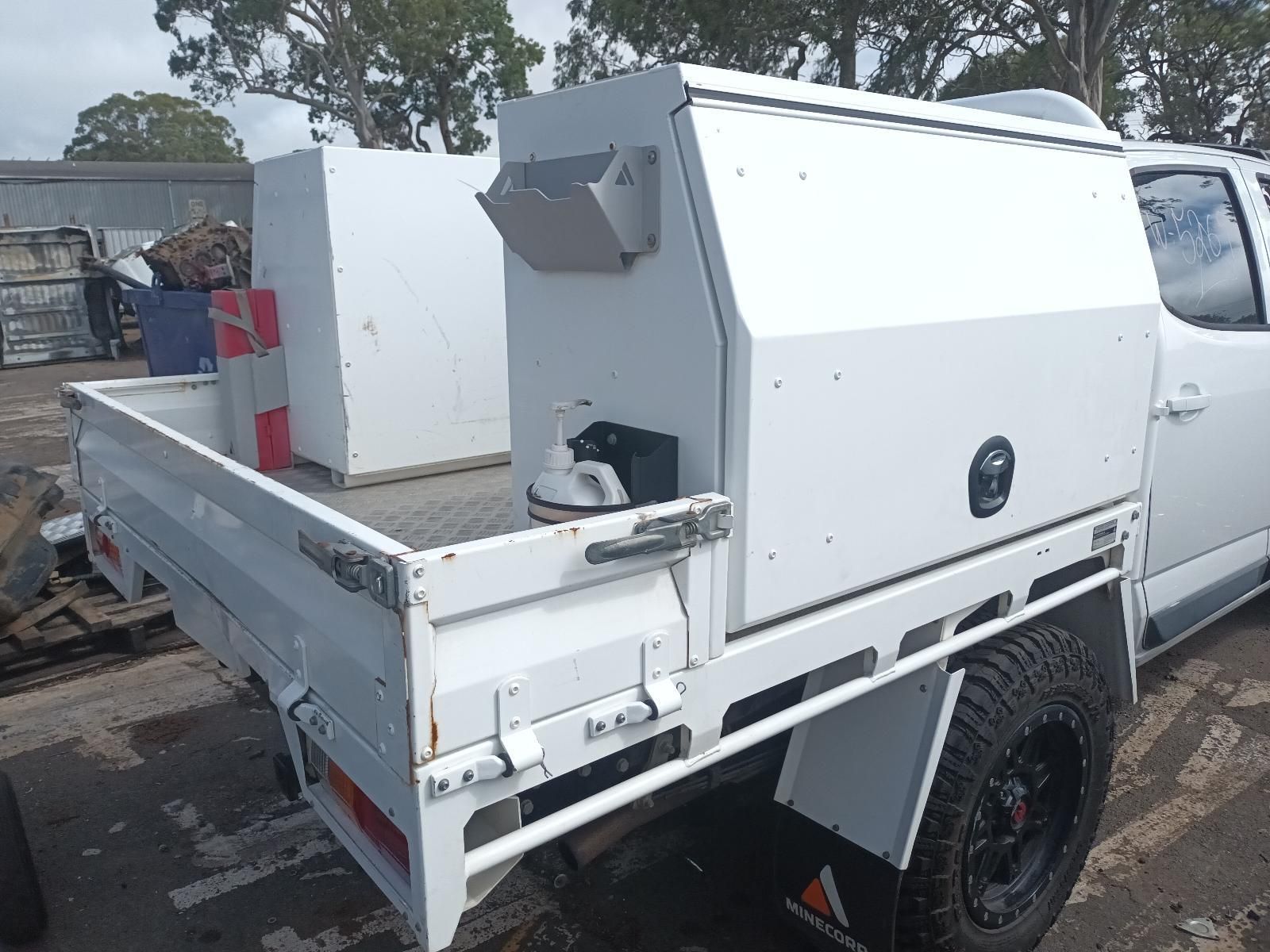 A White Truck with a Toolbox on the Back is Parked in a Parking Lot — South West 4WD Wreckers In Brisbane, QLD