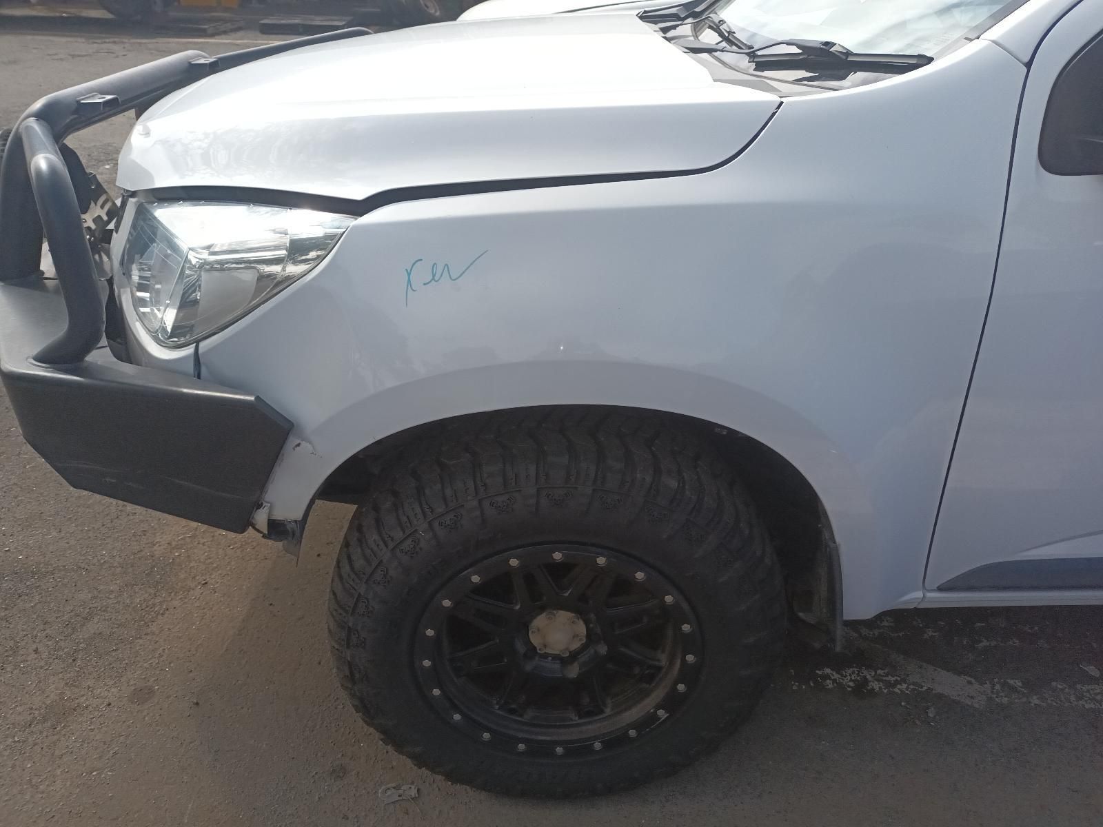 A White Truck with a Black Bumper is Parked on the Side of the Road — South West 4WD Wreckers In Brisbane, QLD
